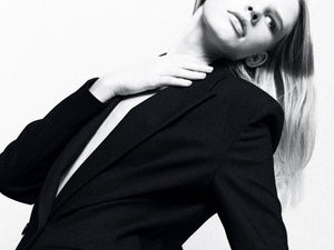 A young woman in black suit stretching her neck. Don't Forget the Neck treatments at Teresa Tarmey 