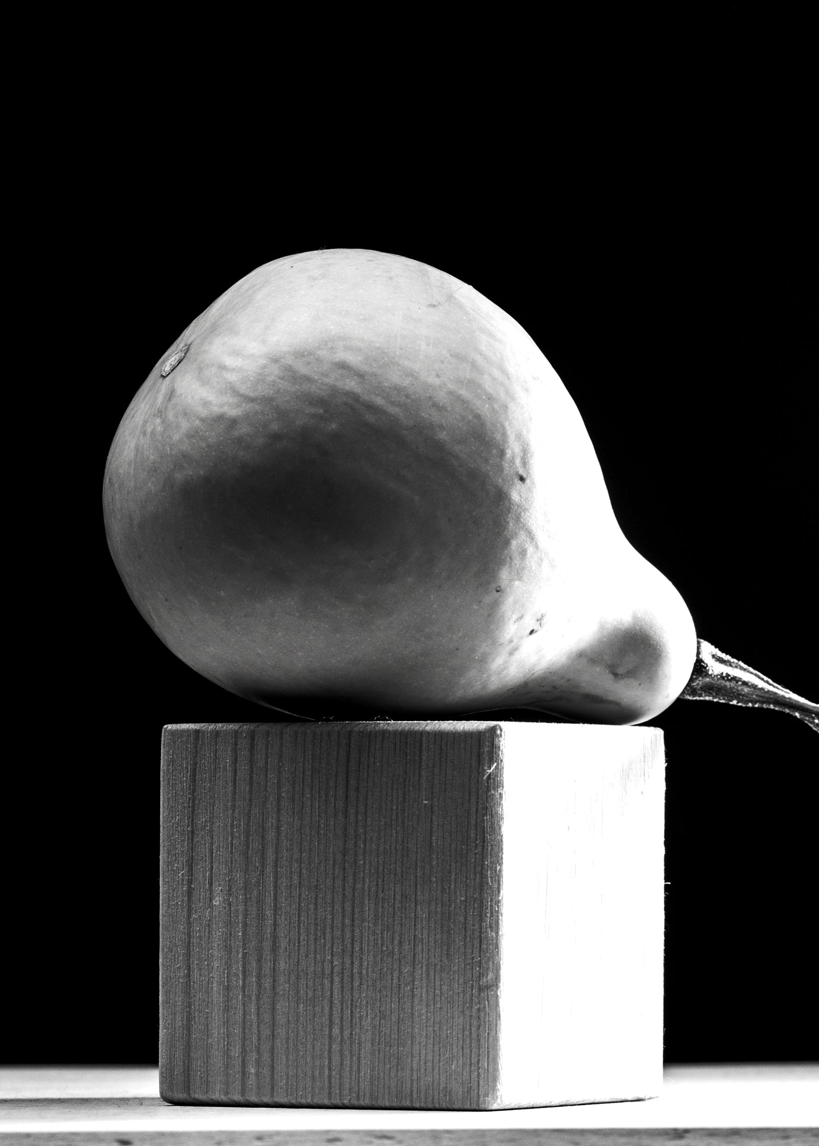 Black and white image of a pear on top of a wooden cube. Medical Weight Loss powered by Effect Doctors. IV Drips available at Teresa Tarmey clinic