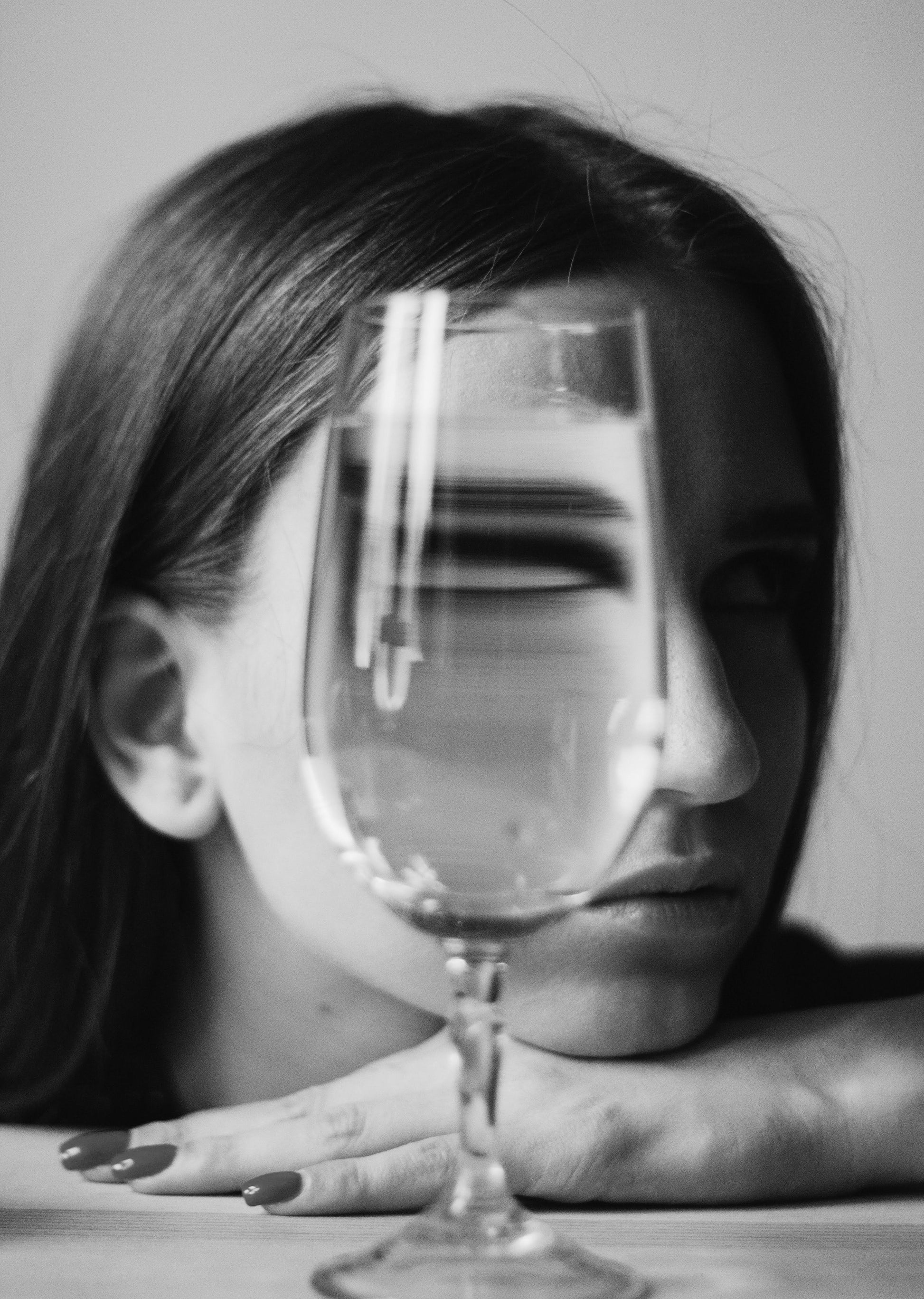 black and white shot of girl with glass of white wine hiding her face. TT Skin Infusion drip. IV Drips at Teresa Tarmey
